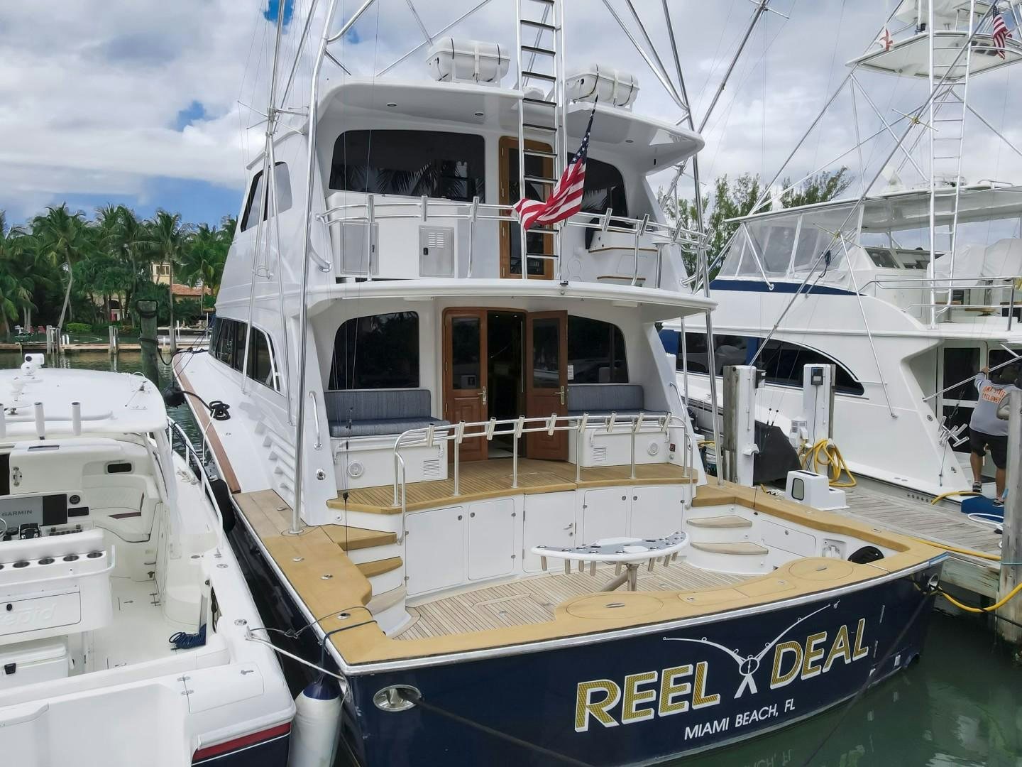 a boat with a flag on the front aboard REEL DEAL Yacht for Sale
