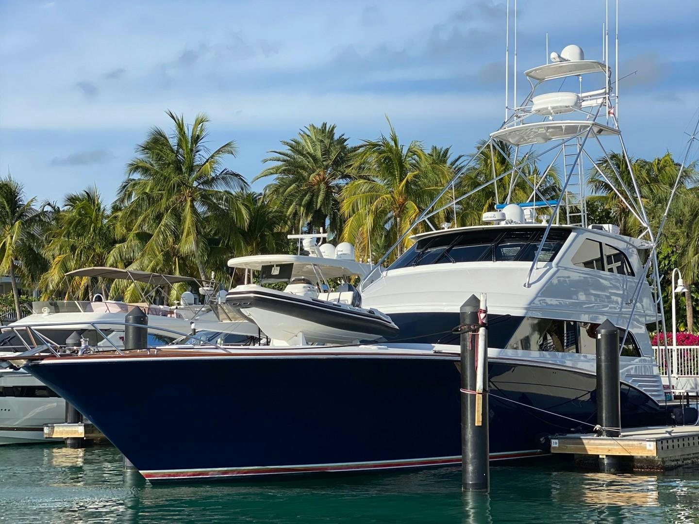 a couple of boats are parked in a harbor aboard REEL DEAL Yacht for Sale
