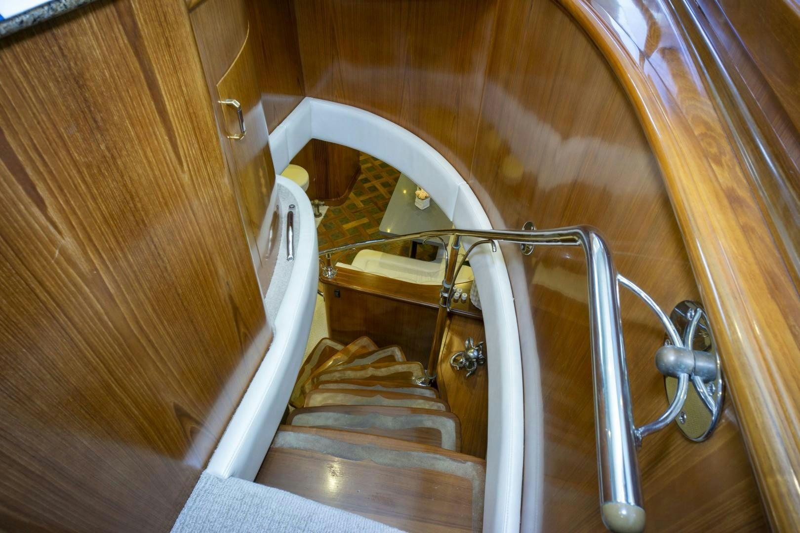 a staircase with a metal railing aboard REEL DEAL Yacht for Sale