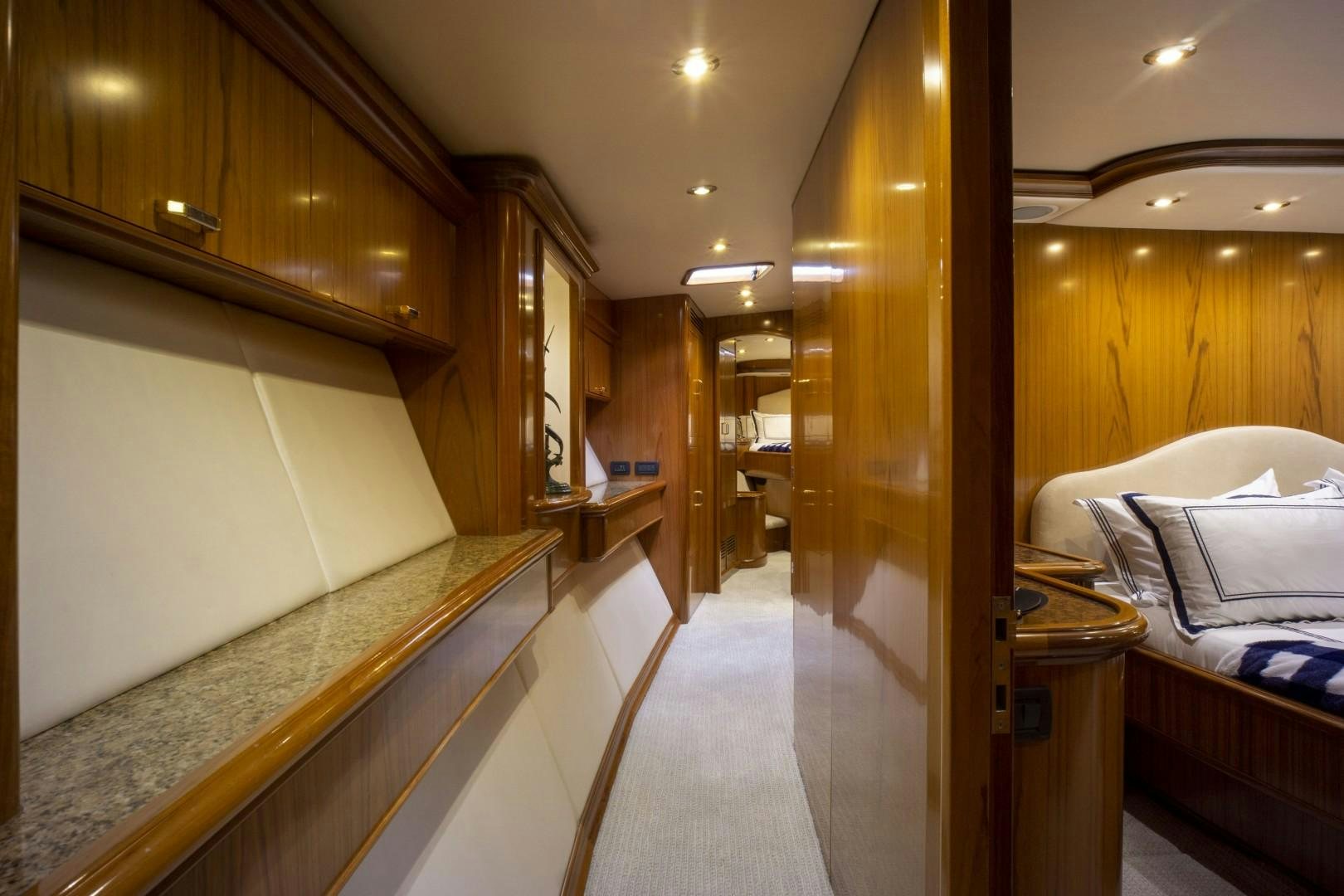 a room with a bed and a mirror aboard REEL DEAL Yacht for Sale