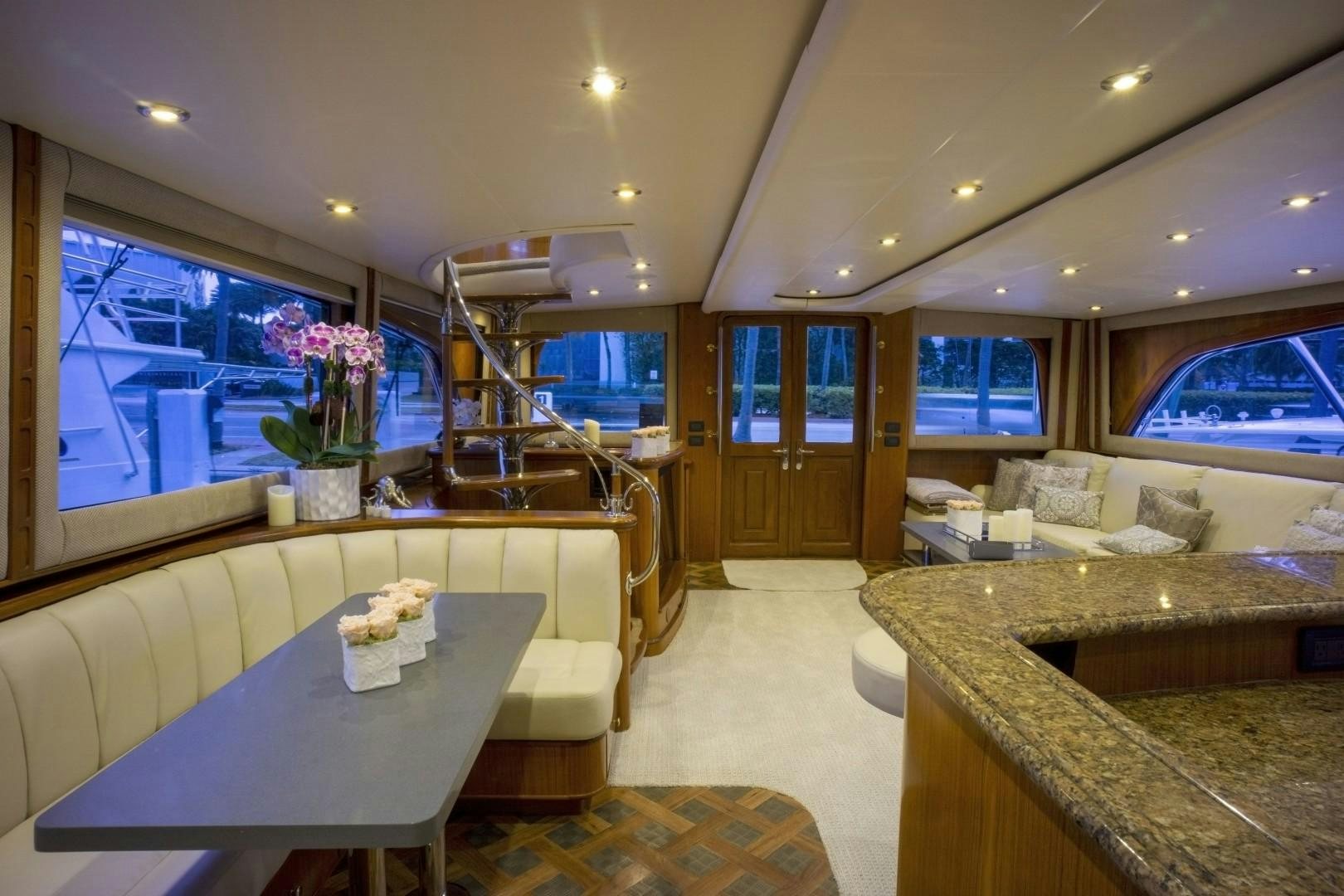 a kitchen with a table and chairs aboard REEL DEAL Yacht for Sale