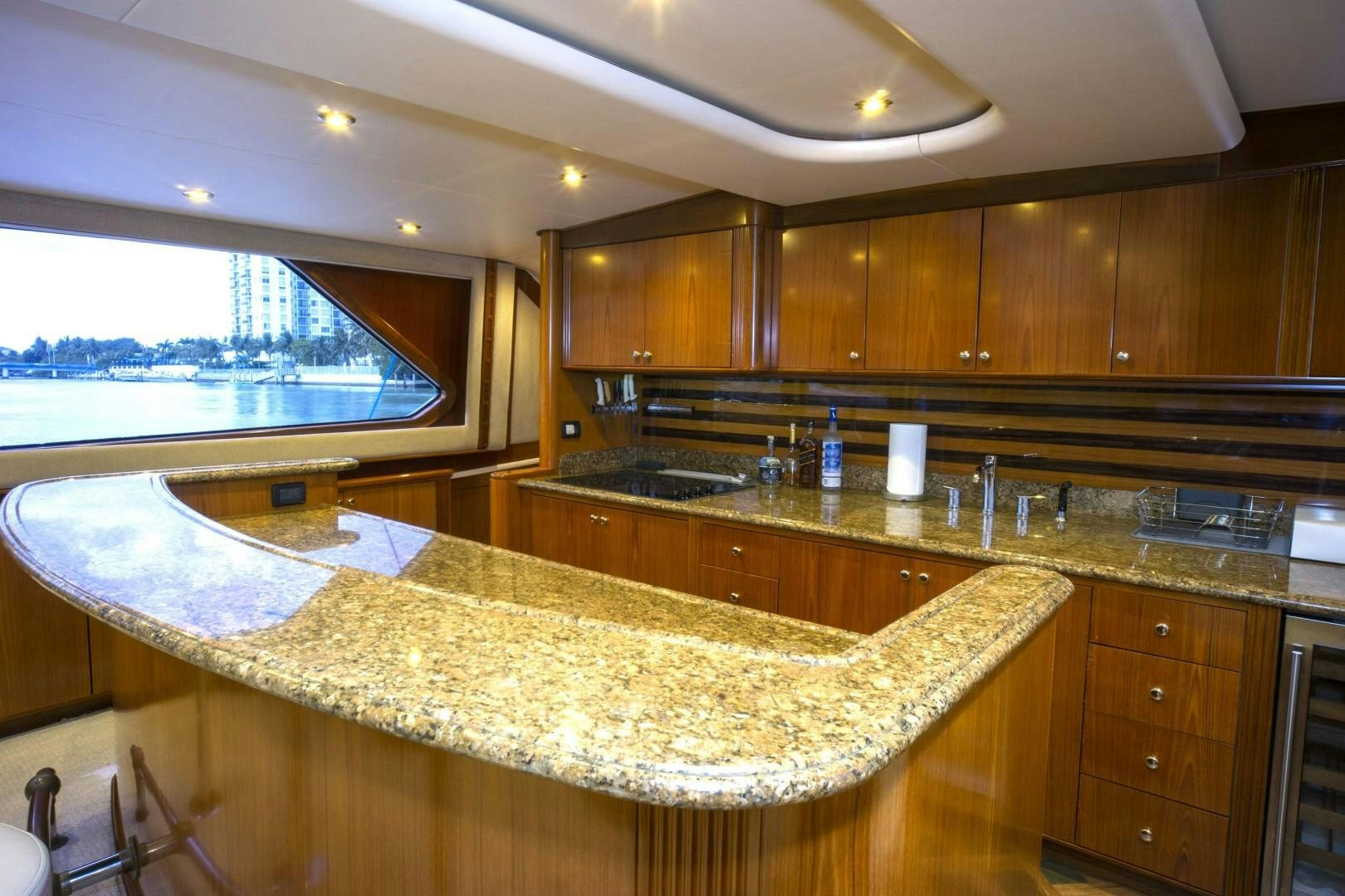 a kitchen with wooden cabinets aboard REEL DEAL Yacht for Sale