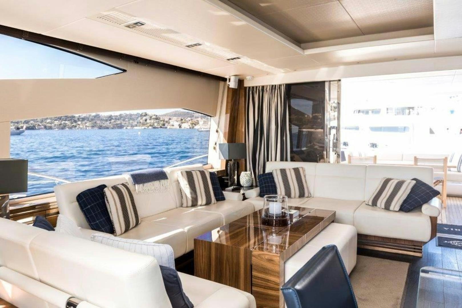 a living room with a large cruise ship in the background aboard ANNEKE Yacht for Sale