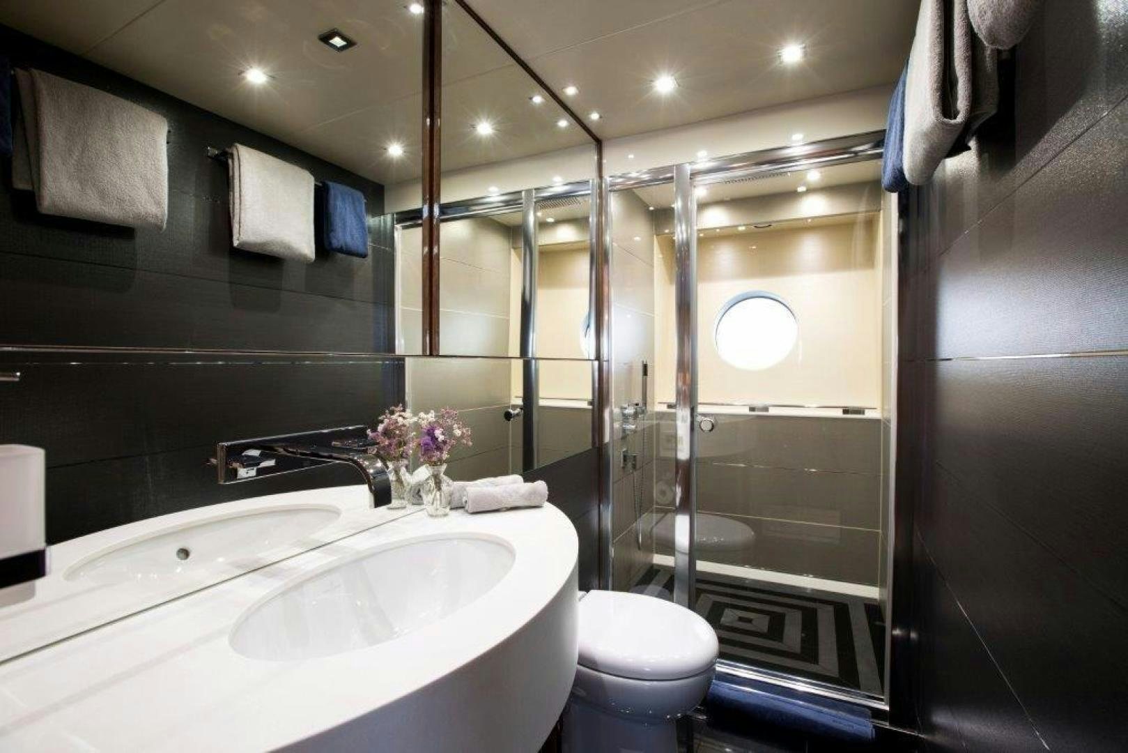 a bathroom with a glass shower aboard ANNEKE Yacht for Sale