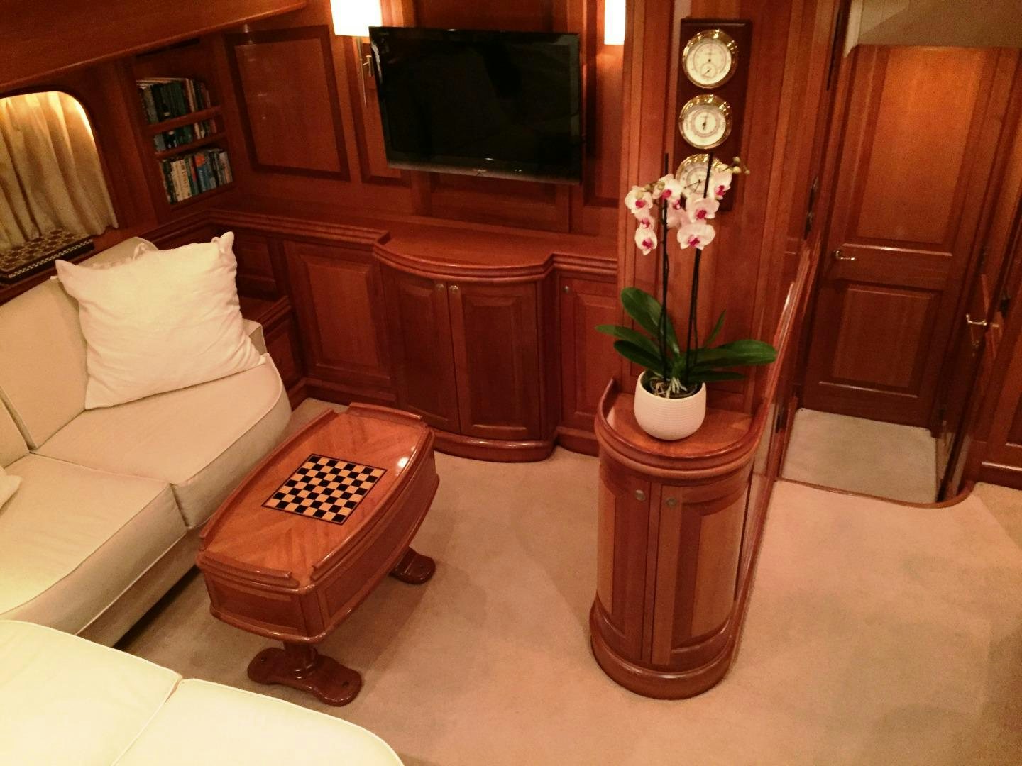a vase of flowers on a table aboard TIGA BELAS Yacht for Sale