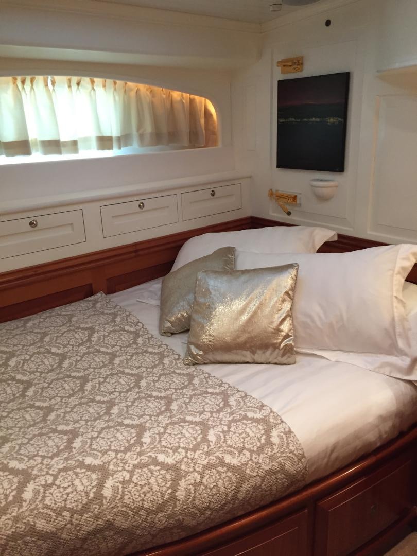 a bed with white sheets aboard TIGA BELAS Yacht for Sale