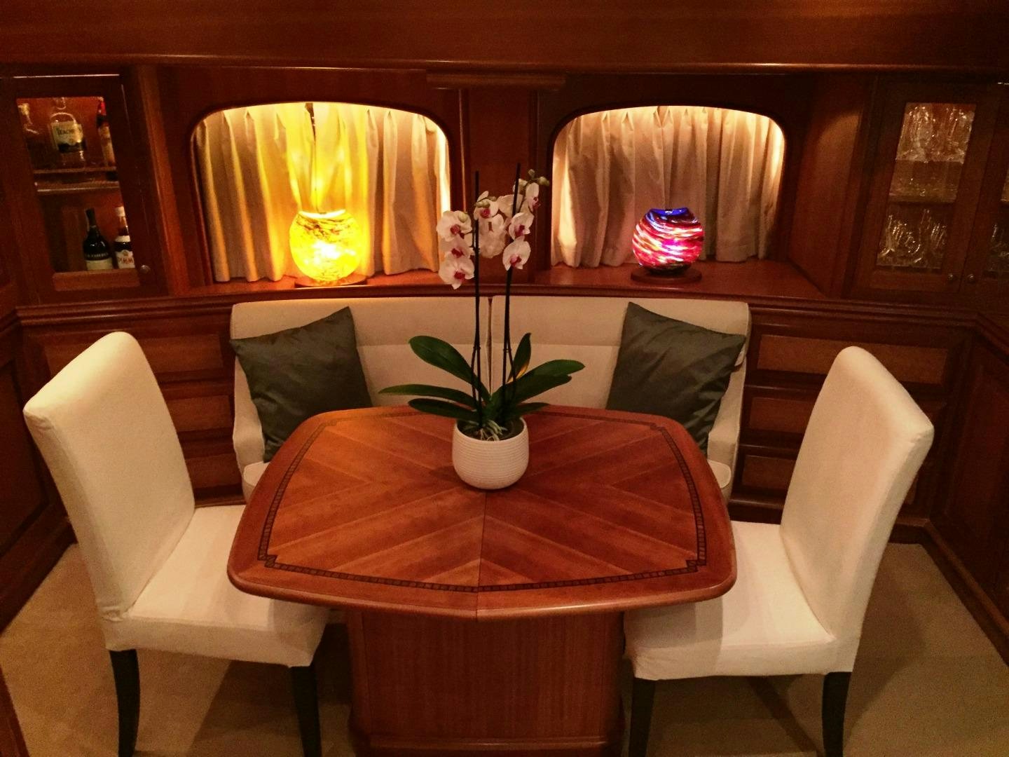 a room with a table and chairs aboard TIGA BELAS Yacht for Sale