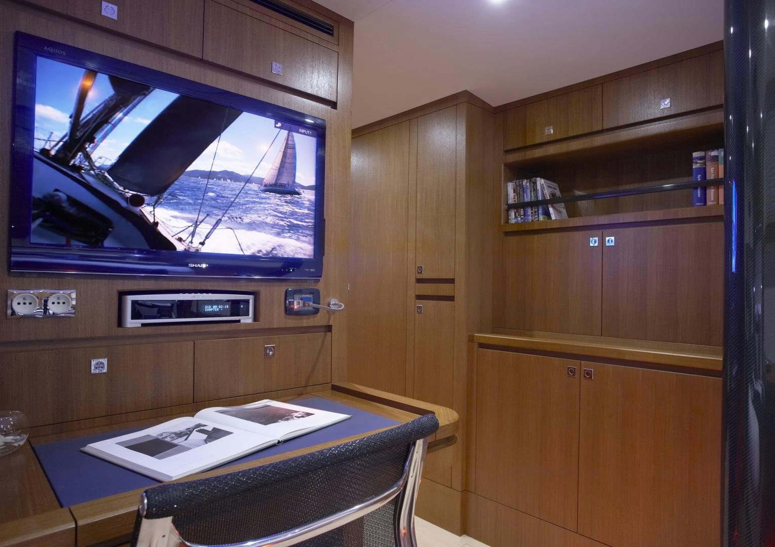 a room with a tv and a table aboard SINGULARITY Yacht for Sale