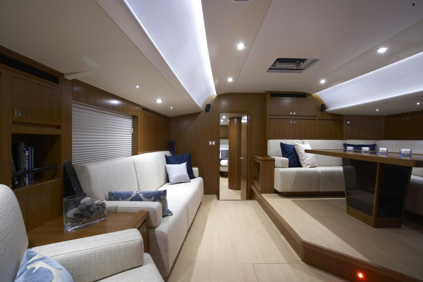 a living room with a couch and a table aboard SINGULARITY Yacht for Sale