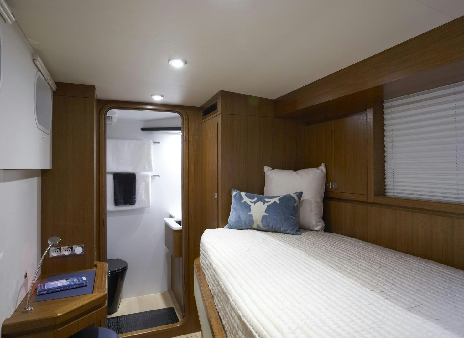 a bedroom with a bed and a mirror aboard SINGULARITY Yacht for Sale