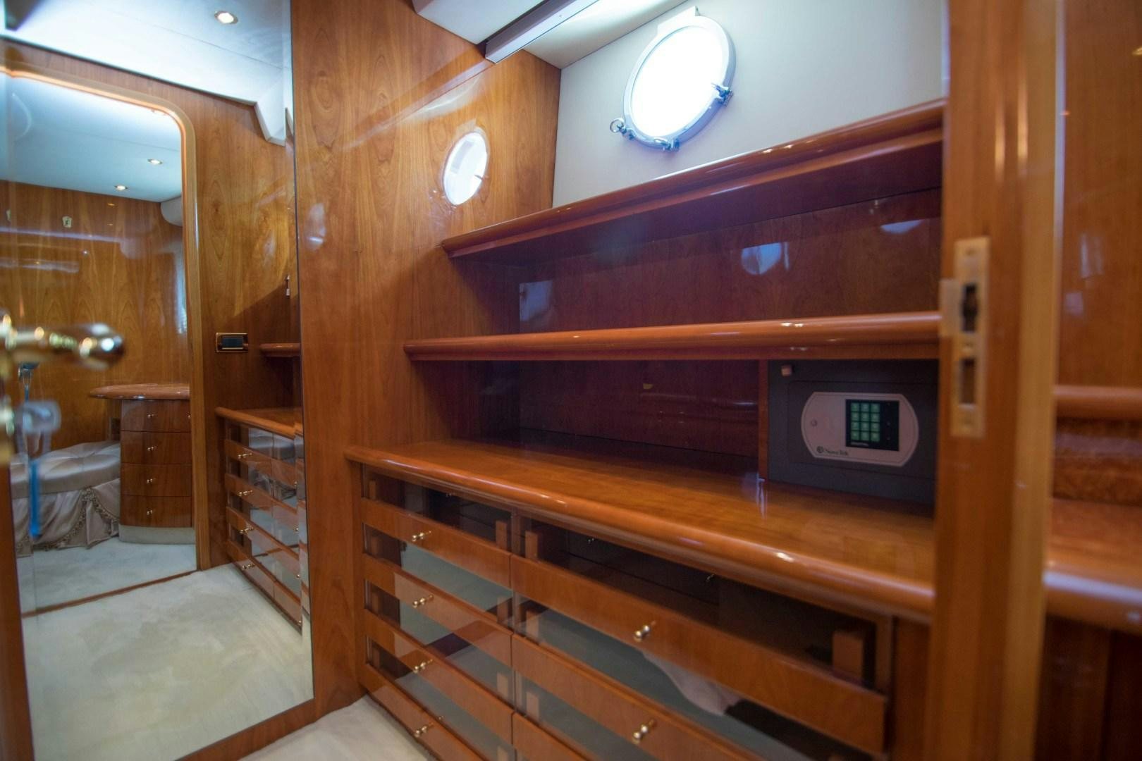 a wooden cabinet with a mirror above it aboard ENCHANTED LADY Yacht for Sale