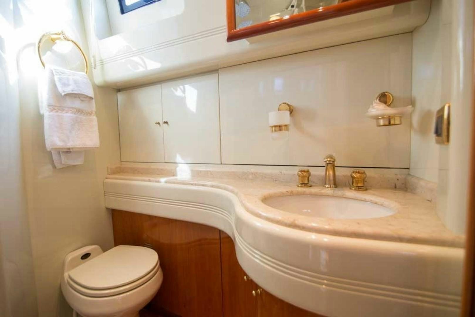 a bathroom with a sink and toilet aboard ENCHANTED LADY Yacht for Sale