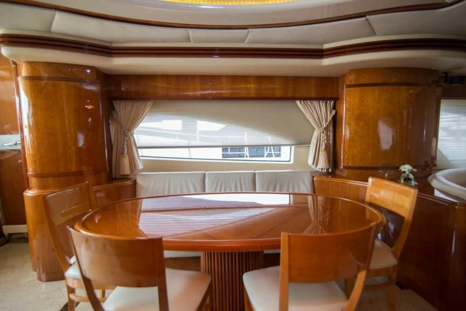 a room with tables and chairs aboard ENCHANTED LADY Yacht for Sale