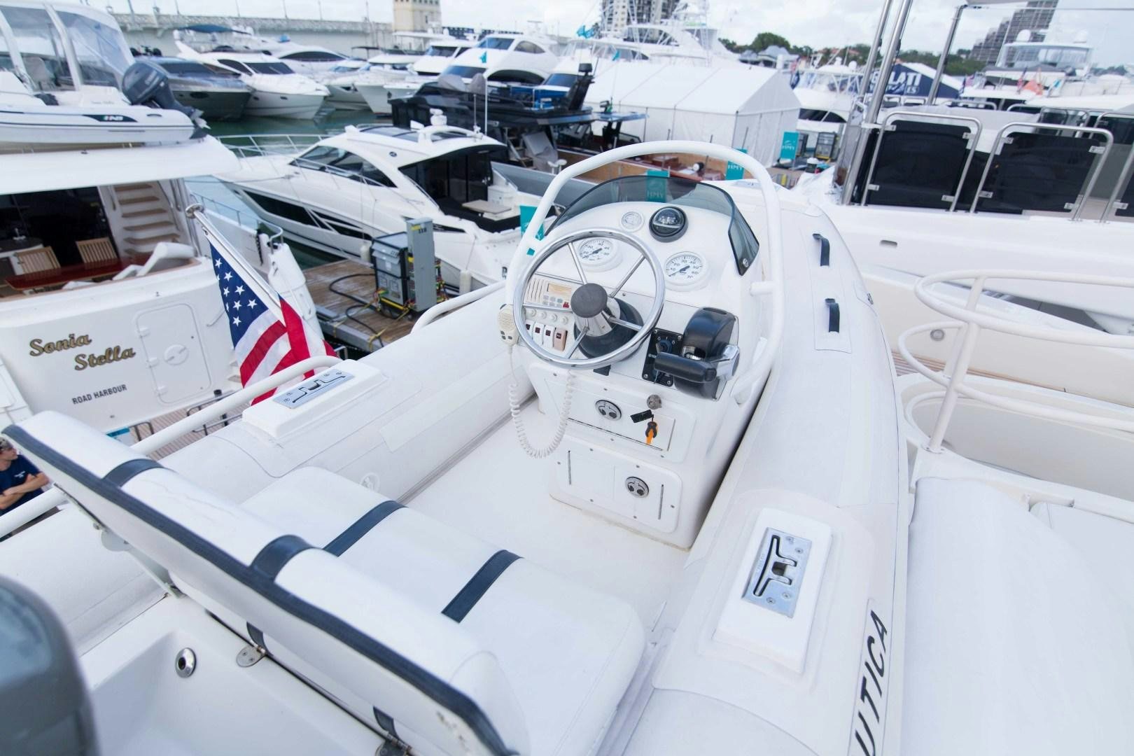 a white boat with a flag on it aboard ENCHANTED LADY Yacht for Sale