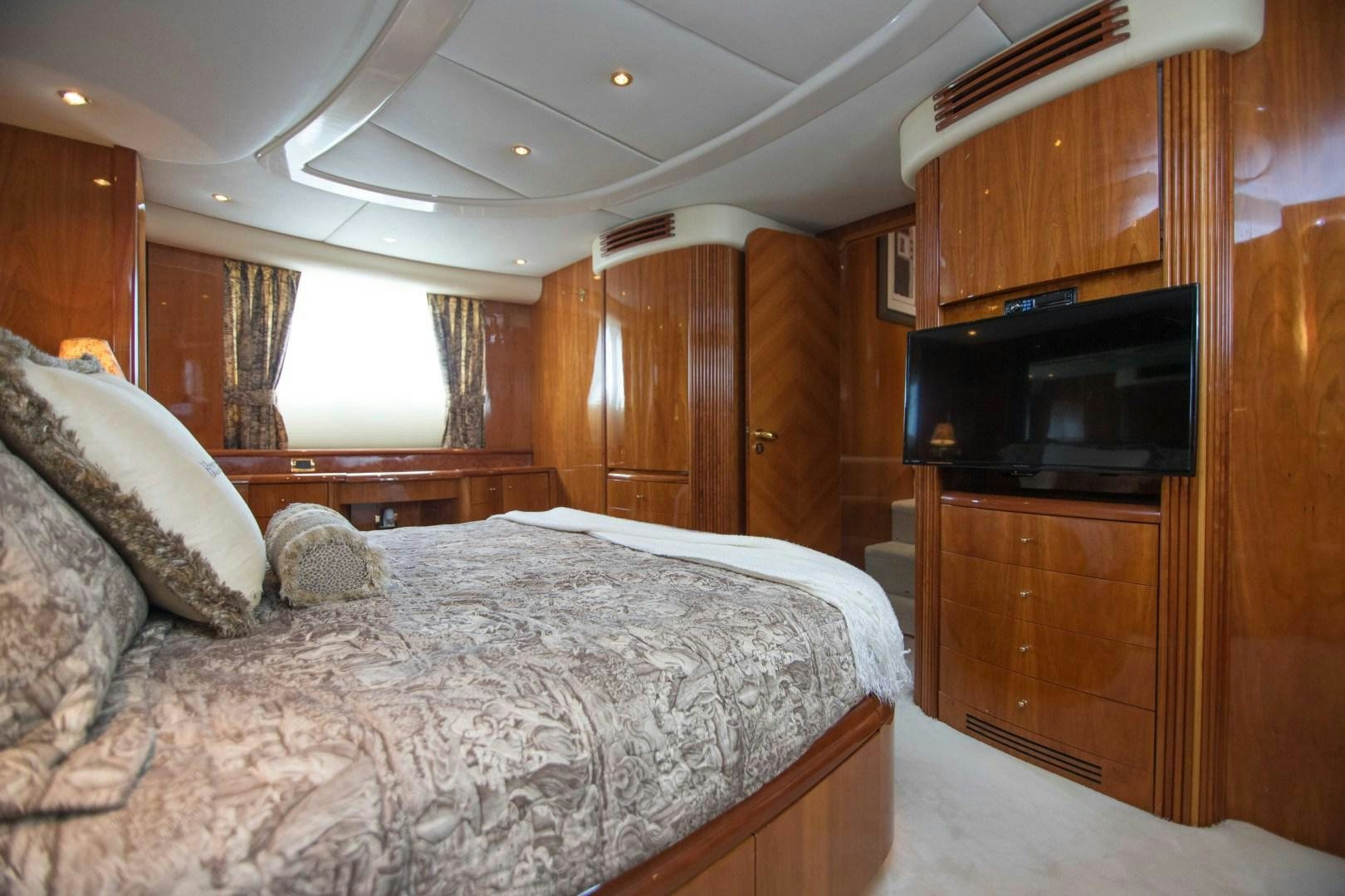 a bedroom with a bed and a television aboard ENCHANTED LADY Yacht for Sale