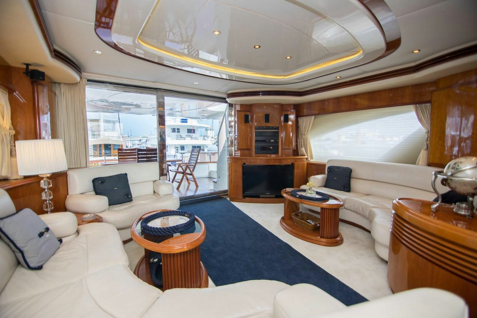 a large room with a large bed and a fireplace aboard ENCHANTED LADY Yacht for Sale