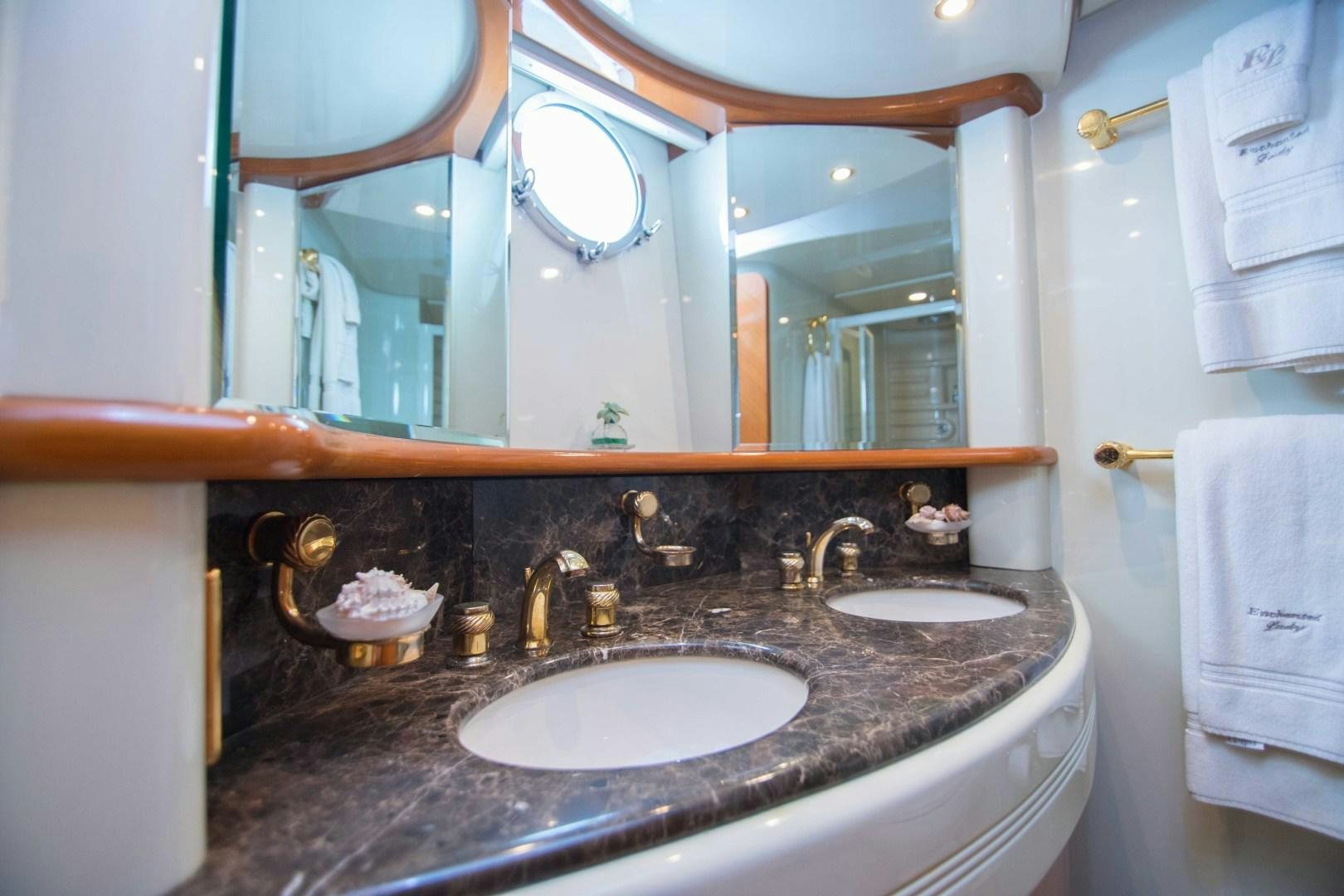 a bathroom with a large mirror aboard ENCHANTED LADY Yacht for Sale