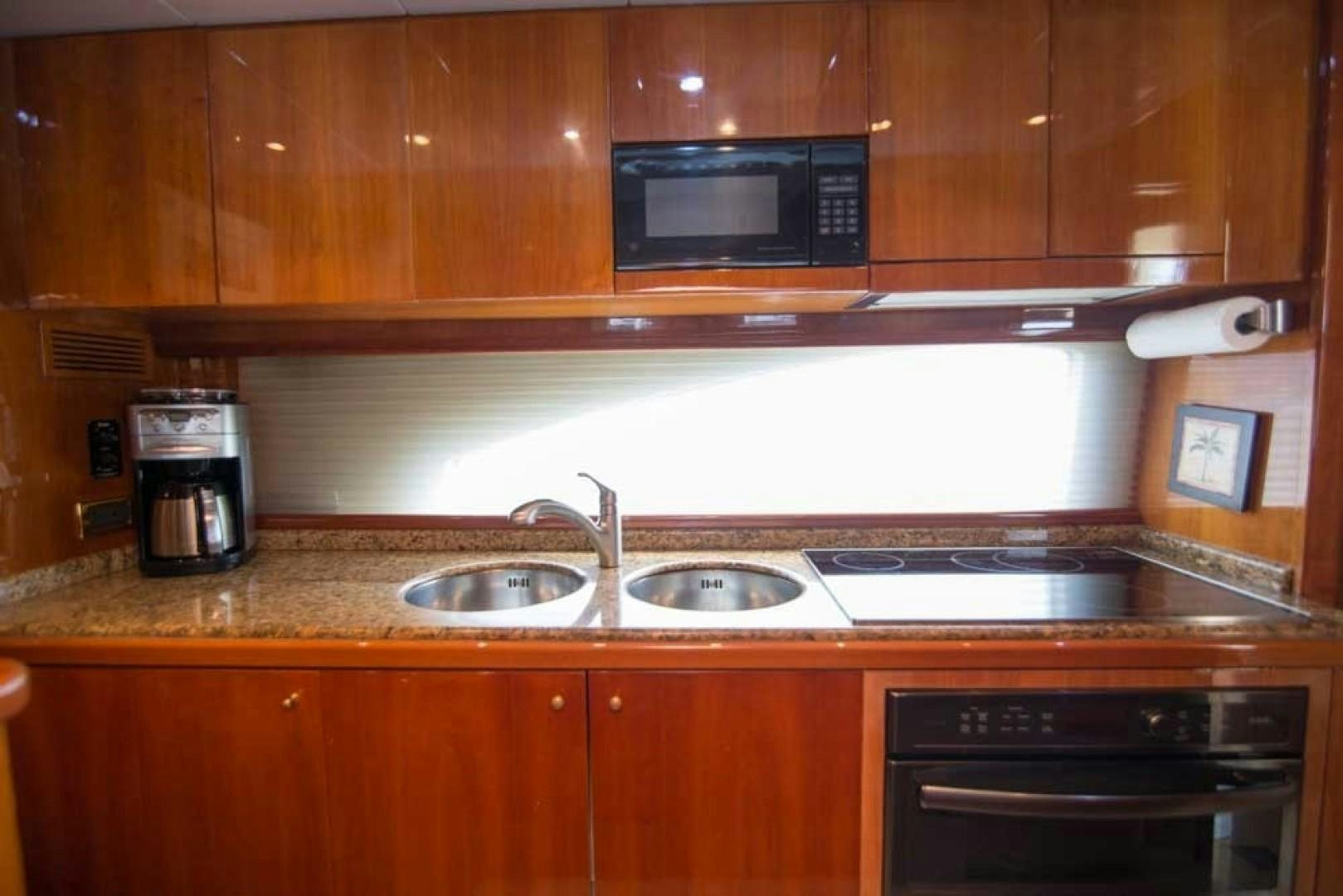 a kitchen with wooden cabinets aboard ENCHANTED LADY Yacht for Sale