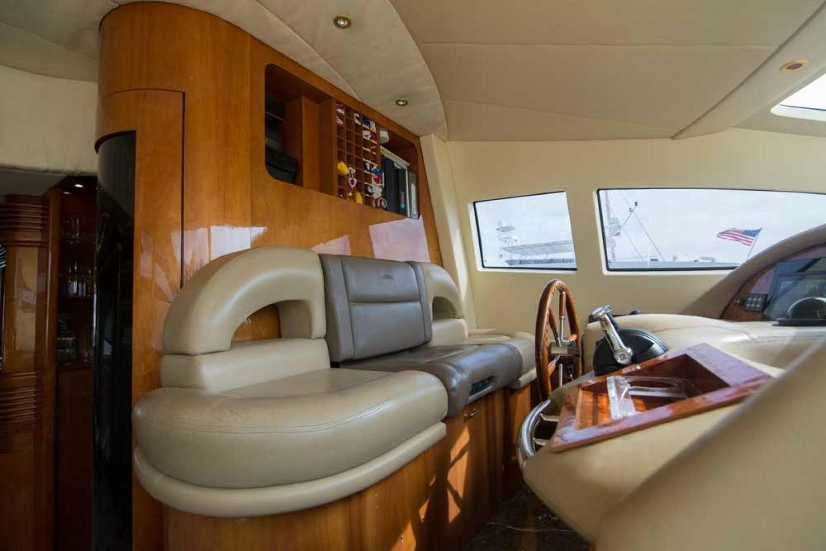 a small living room with a small kitchen and a dining table aboard ENCHANTED LADY Yacht for Sale