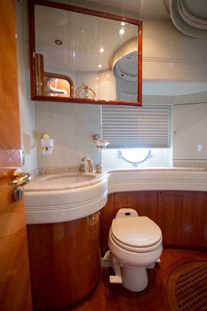 a bathroom with a toilet and sink aboard ENCHANTED LADY Yacht for Sale