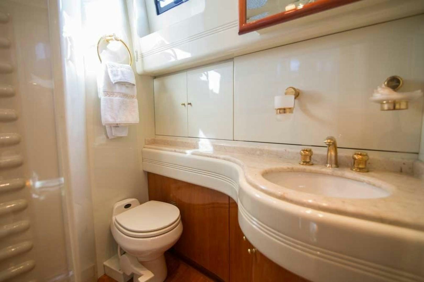 a bathroom with a sink and toilet aboard ENCHANTED LADY Yacht for Sale