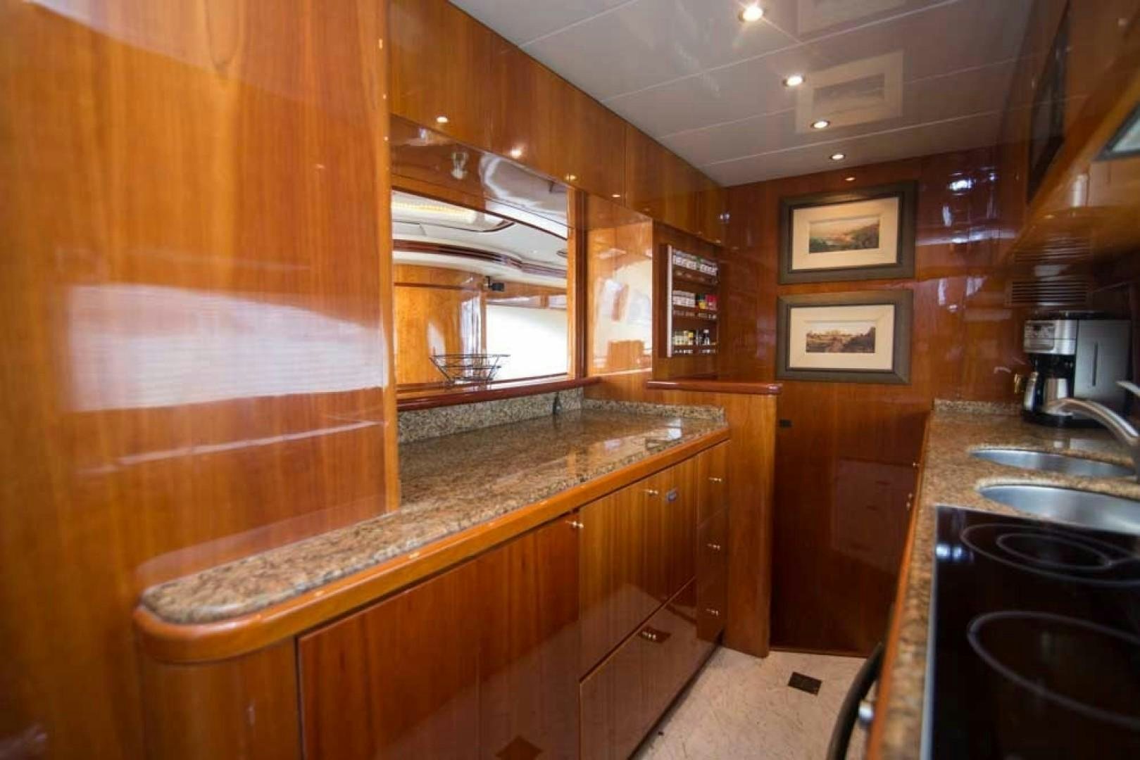 a kitchen with wooden cabinets aboard ENCHANTED LADY Yacht for Sale