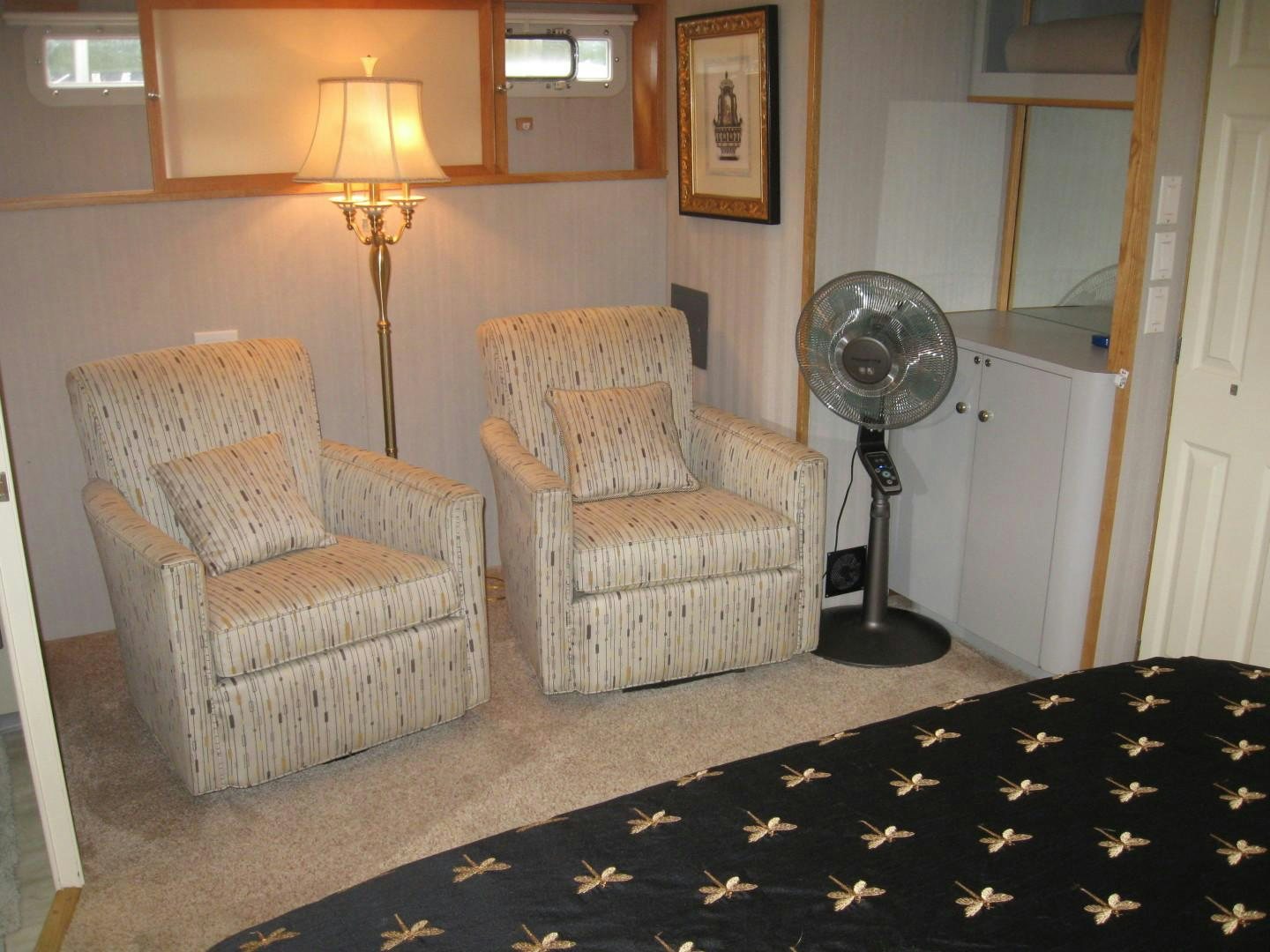 a living room with a fan aboard OCEAN ROMANCE Yacht for Sale