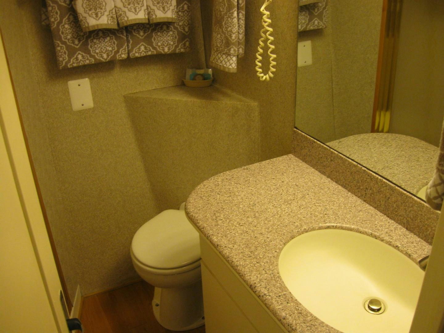 a bathroom with a sink toilet and a bathtub aboard OCEAN ROMANCE Yacht for Sale