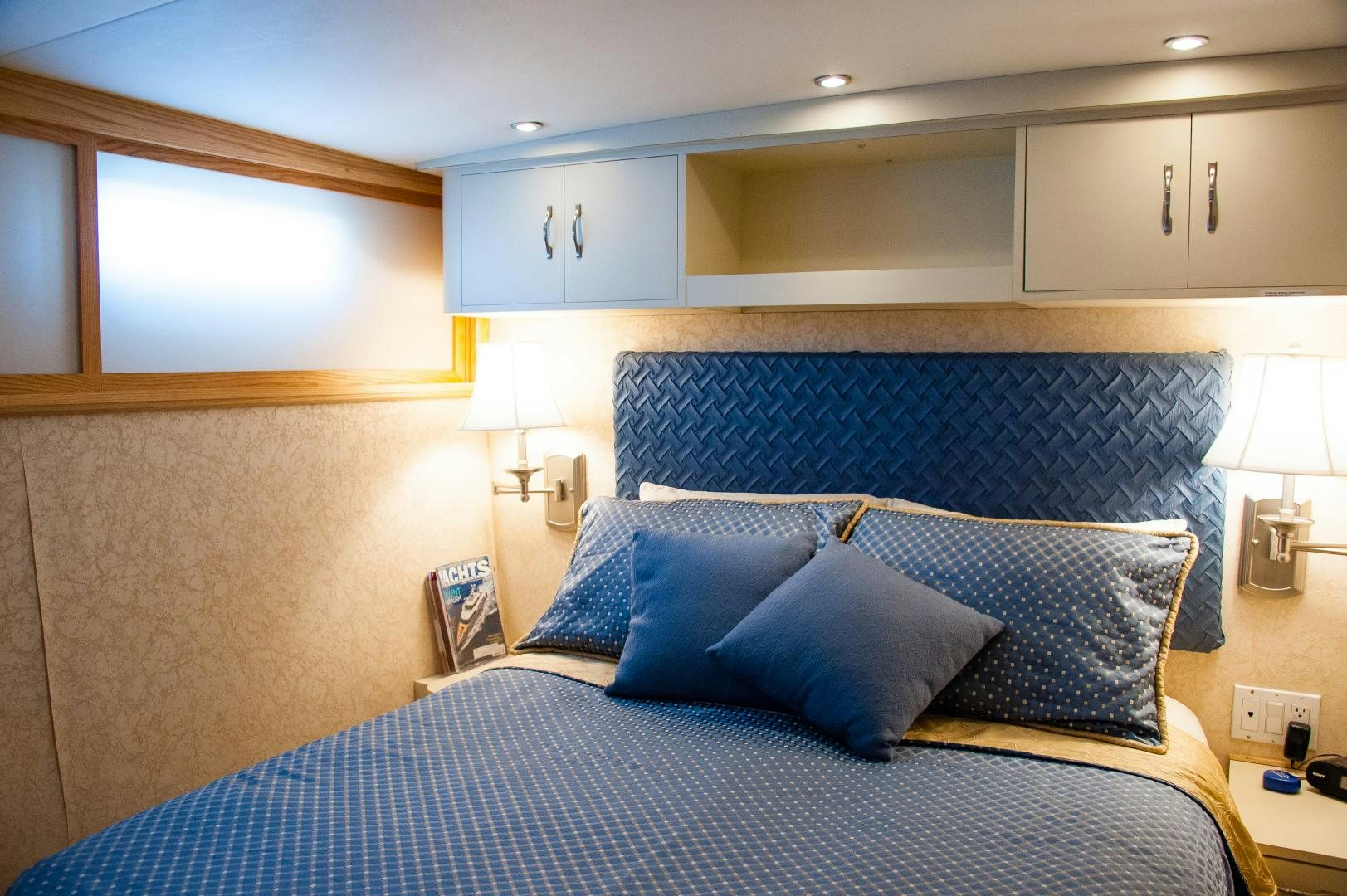 a bed with blue sheets aboard OCEAN ROMANCE Yacht for Sale
