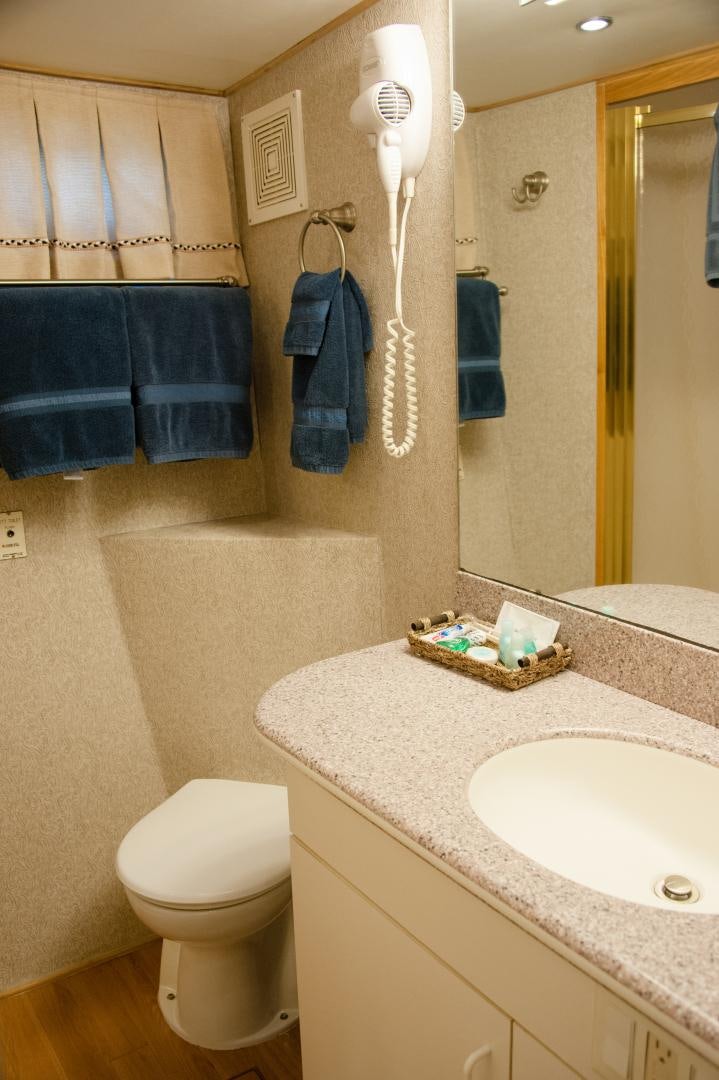 a bathroom with a toilet and a sink aboard OCEAN ROMANCE Yacht for Sale