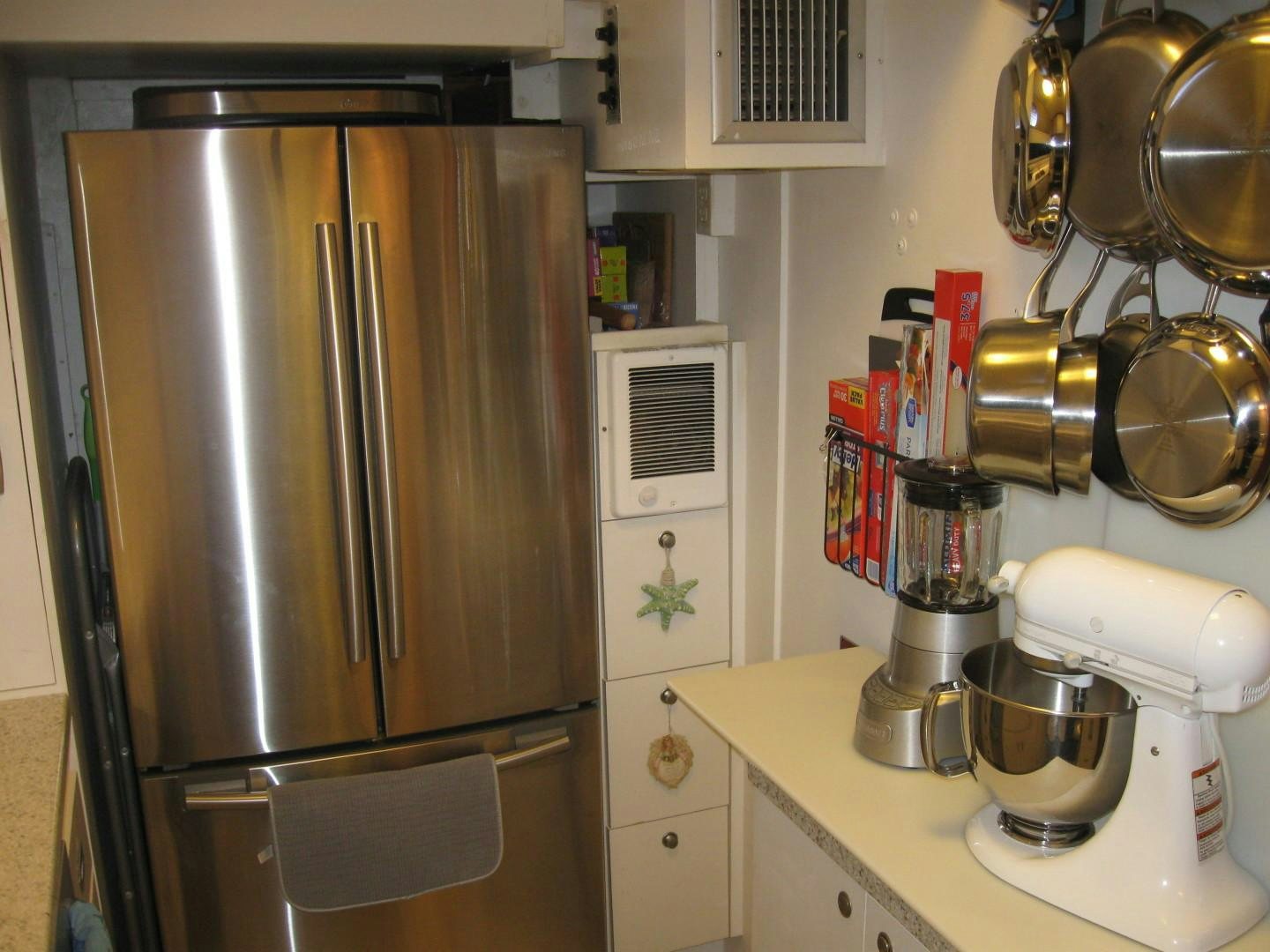 a kitchen with a stainless steel refrigerator aboard OCEAN ROMANCE Yacht for Sale