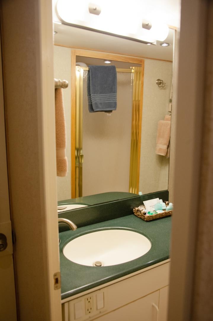 a bathroom with a sink and a mirror aboard OCEAN ROMANCE Yacht for Sale