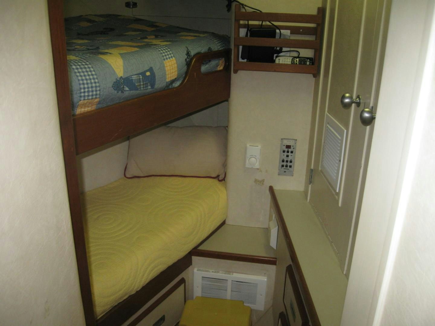 a room with a bed and a shelf aboard OCEAN ROMANCE Yacht for Sale