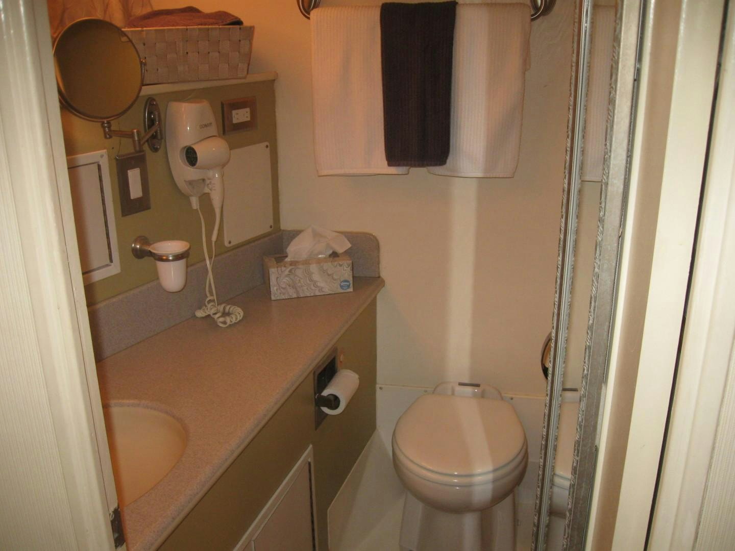 a bathroom with a toilet and sink aboard OCEAN ROMANCE Yacht for Sale