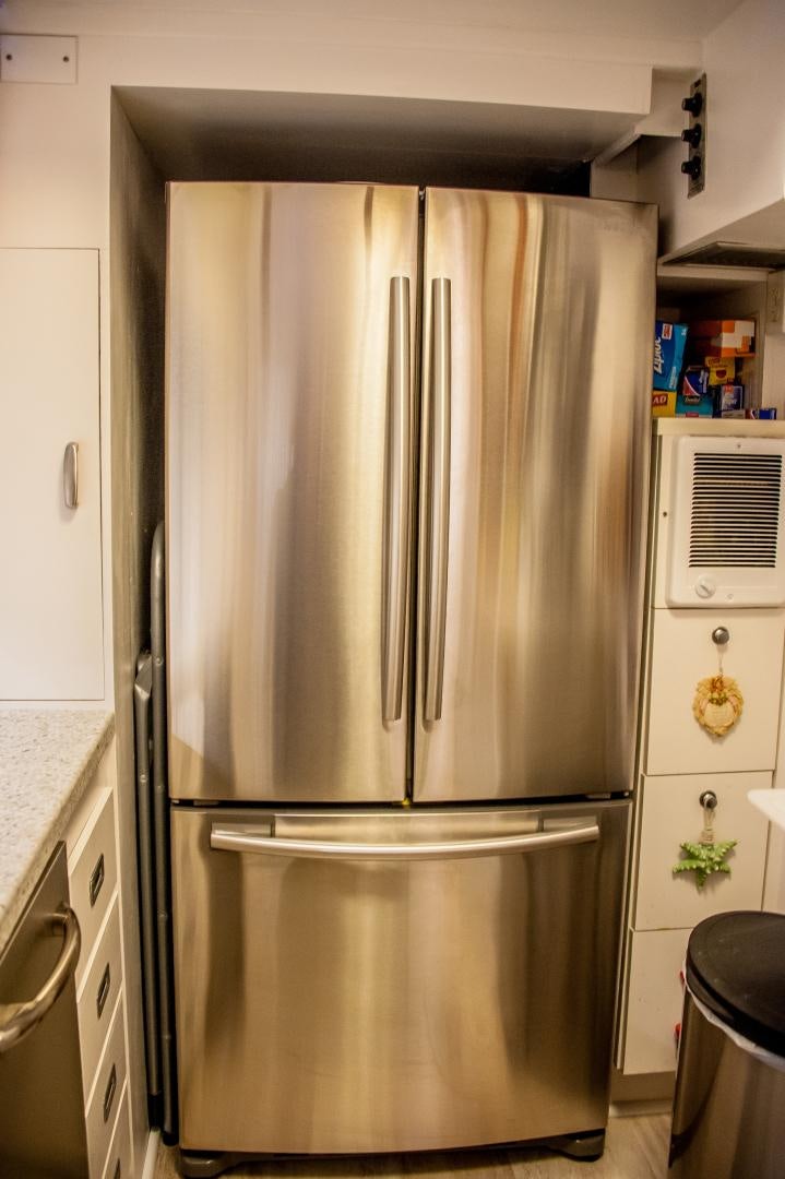 a stainless steel refrigerator in a kitchen aboard OCEAN ROMANCE Yacht for Sale