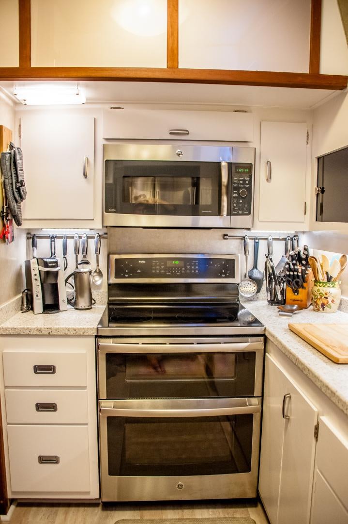 a kitchen with white cabinets aboard OCEAN ROMANCE Yacht for Sale