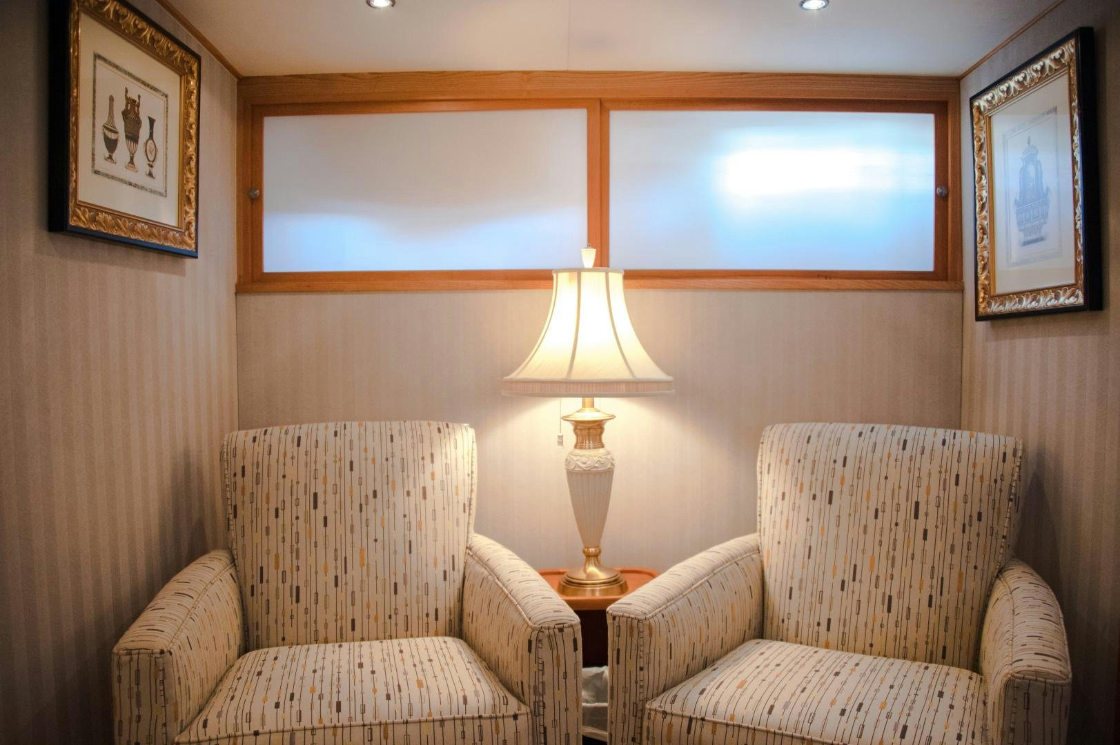 a room with two chairs and a lamp aboard OCEAN ROMANCE Yacht for Sale