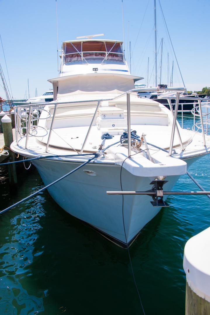 a white boat in a harbor aboard OCEAN ROMANCE Yacht for Sale