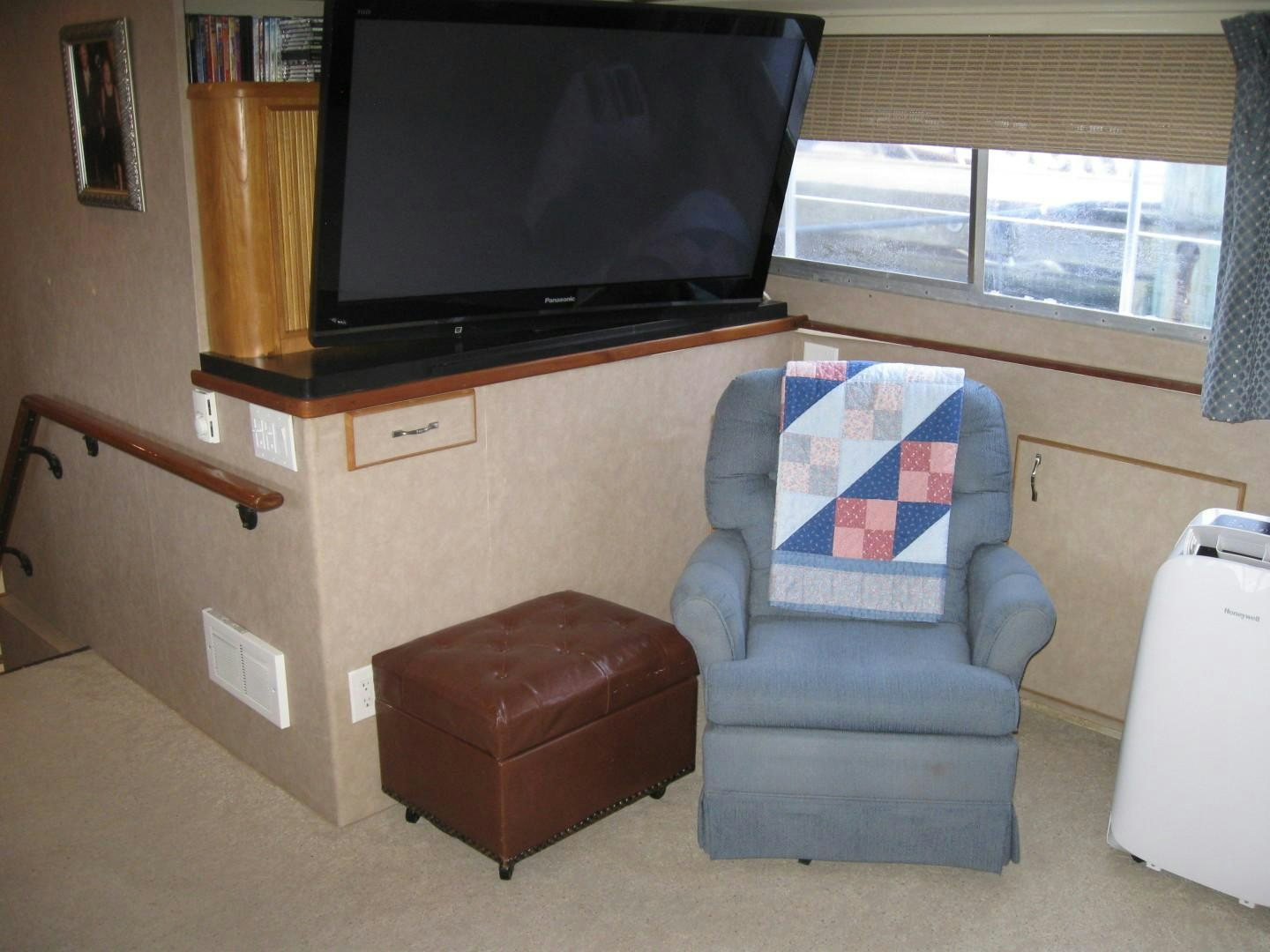 a living room with a tv and a chair aboard OCEAN ROMANCE Yacht for Sale