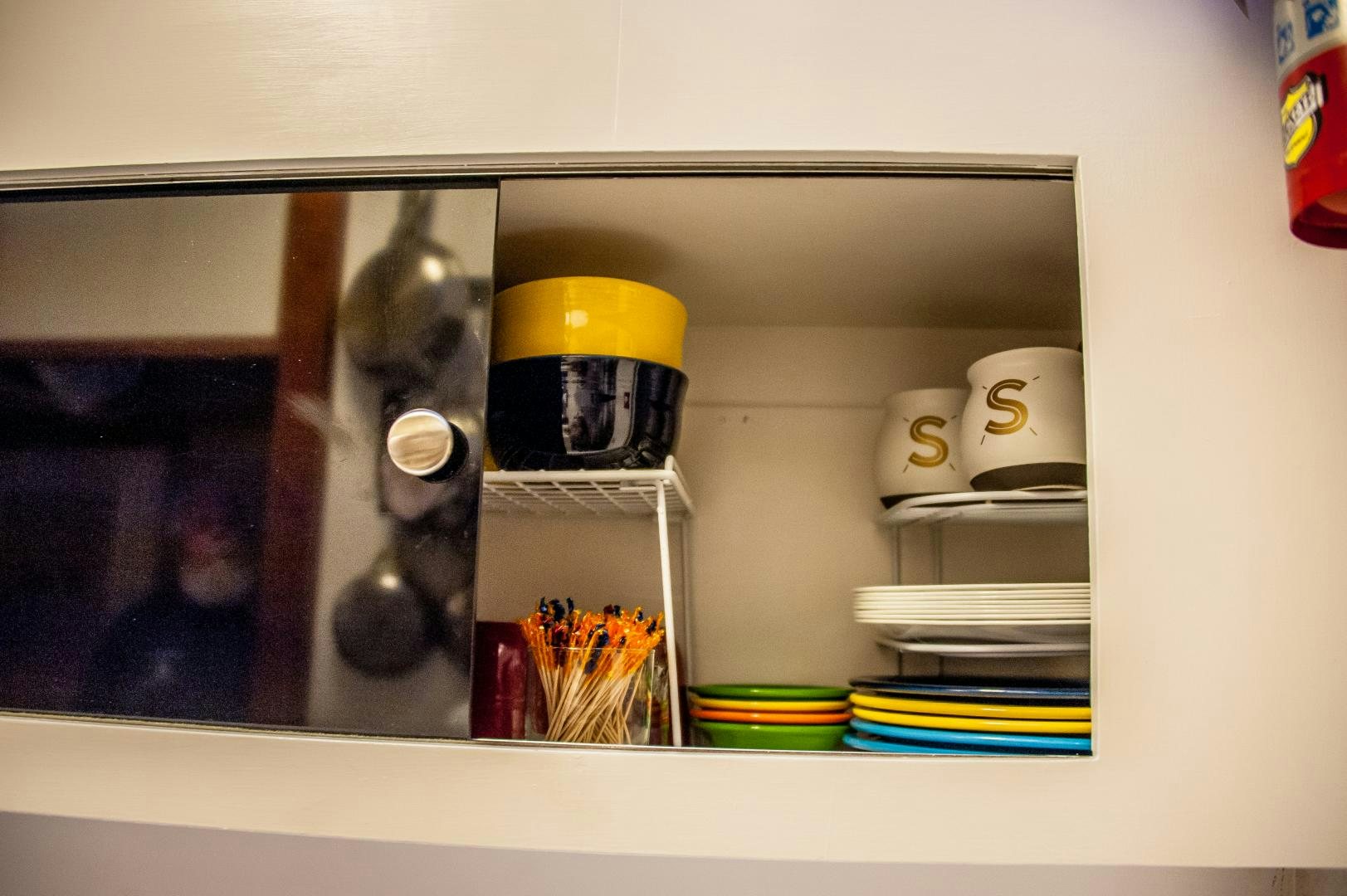 a shelf with a glass jar and a glass jar with a yellow lid aboard OCEAN ROMANCE Yacht for Sale