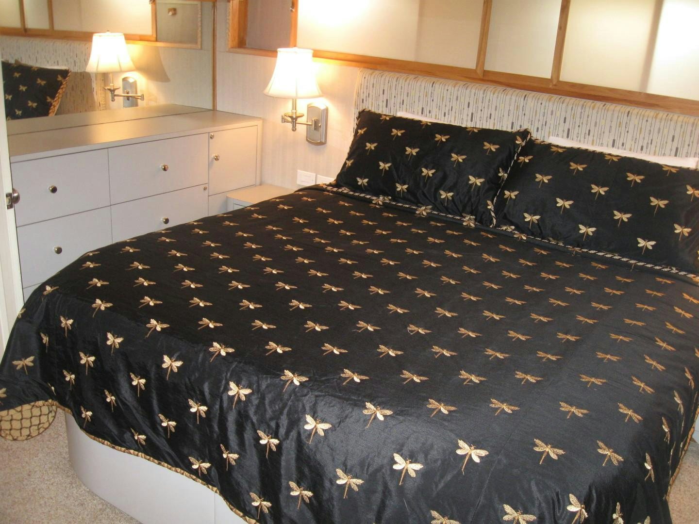 a bed with black and white sheets aboard OCEAN ROMANCE Yacht for Sale