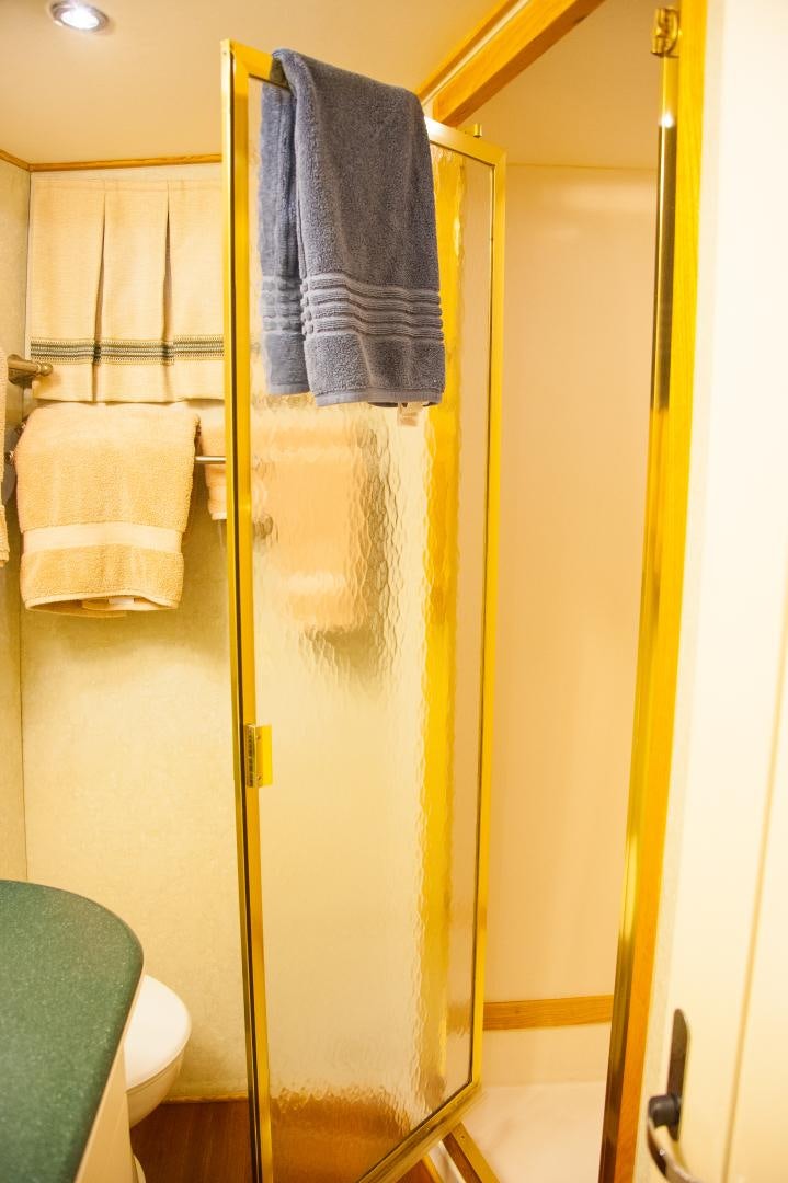 a bathroom with a shower curtain aboard OCEAN ROMANCE Yacht for Sale