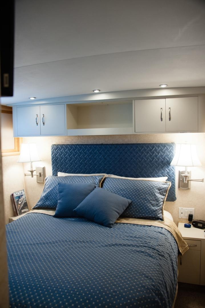 a bed with blue sheets aboard OCEAN ROMANCE Yacht for Sale