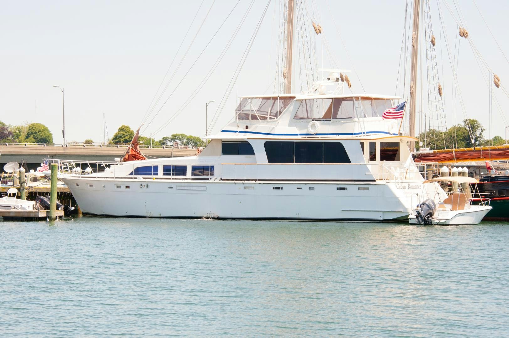 a large white boat in a harbor aboard OCEAN ROMANCE Yacht for Sale
