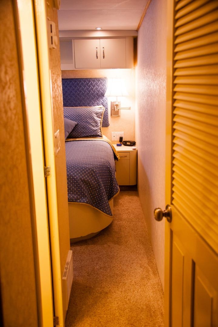 a bedroom with a bed and a door aboard OCEAN ROMANCE Yacht for Sale