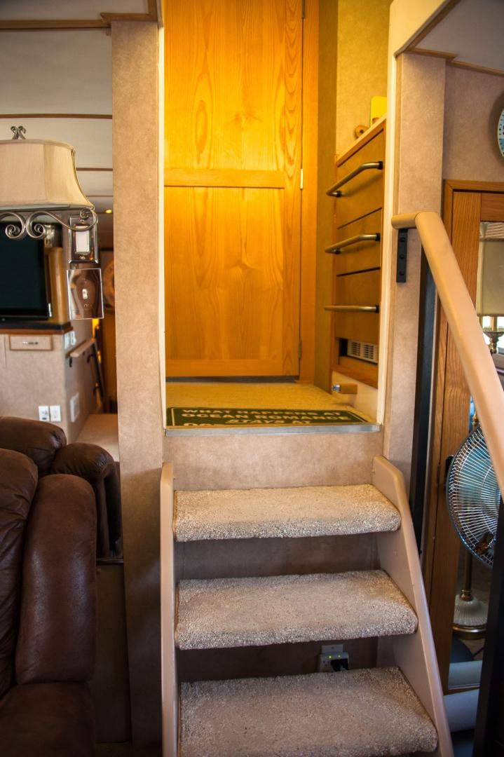 a staircase with a wood railing aboard OCEAN ROMANCE Yacht for Sale