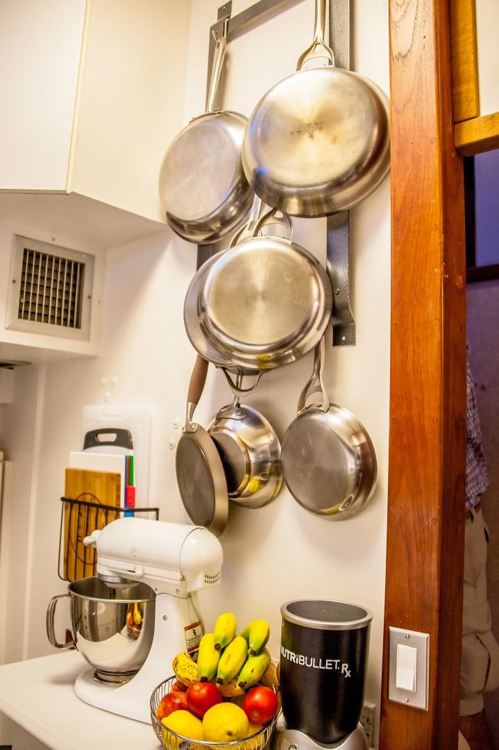 a kitchen with a large silver pot and a bunch of fruits on the counter aboard OCEAN ROMANCE Yacht for Sale