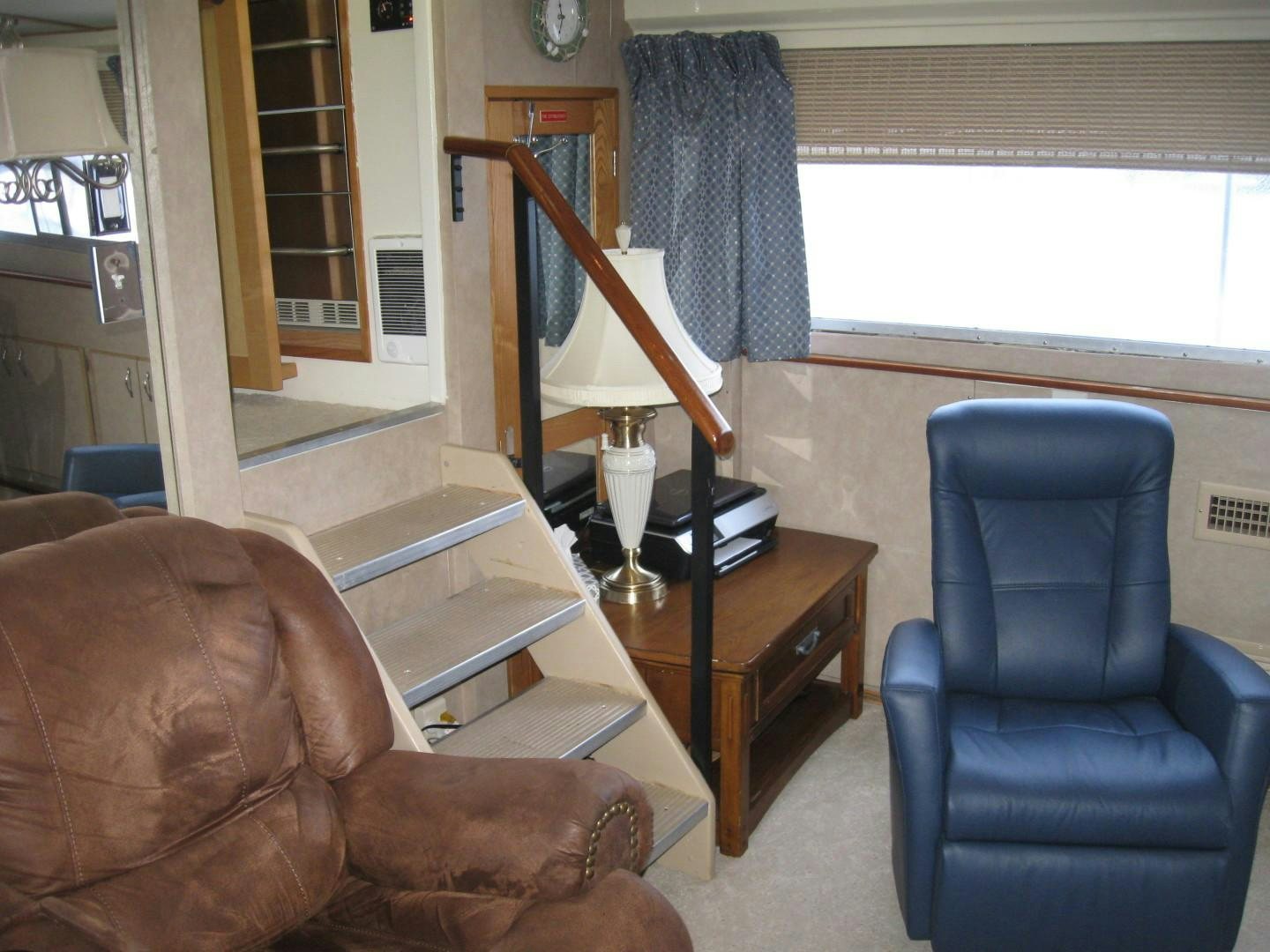 a living room with a piano and a chair aboard OCEAN ROMANCE Yacht for Sale