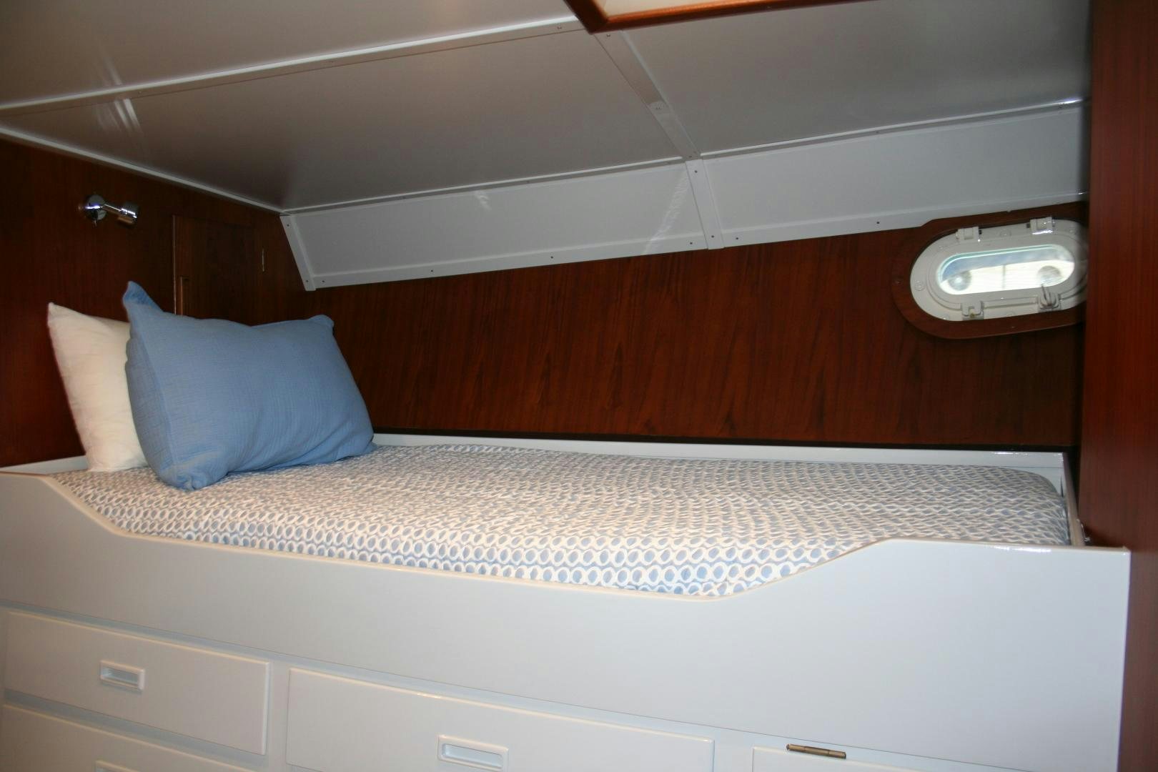 a bed with a white pillow aboard SINDBAD Yacht for Sale