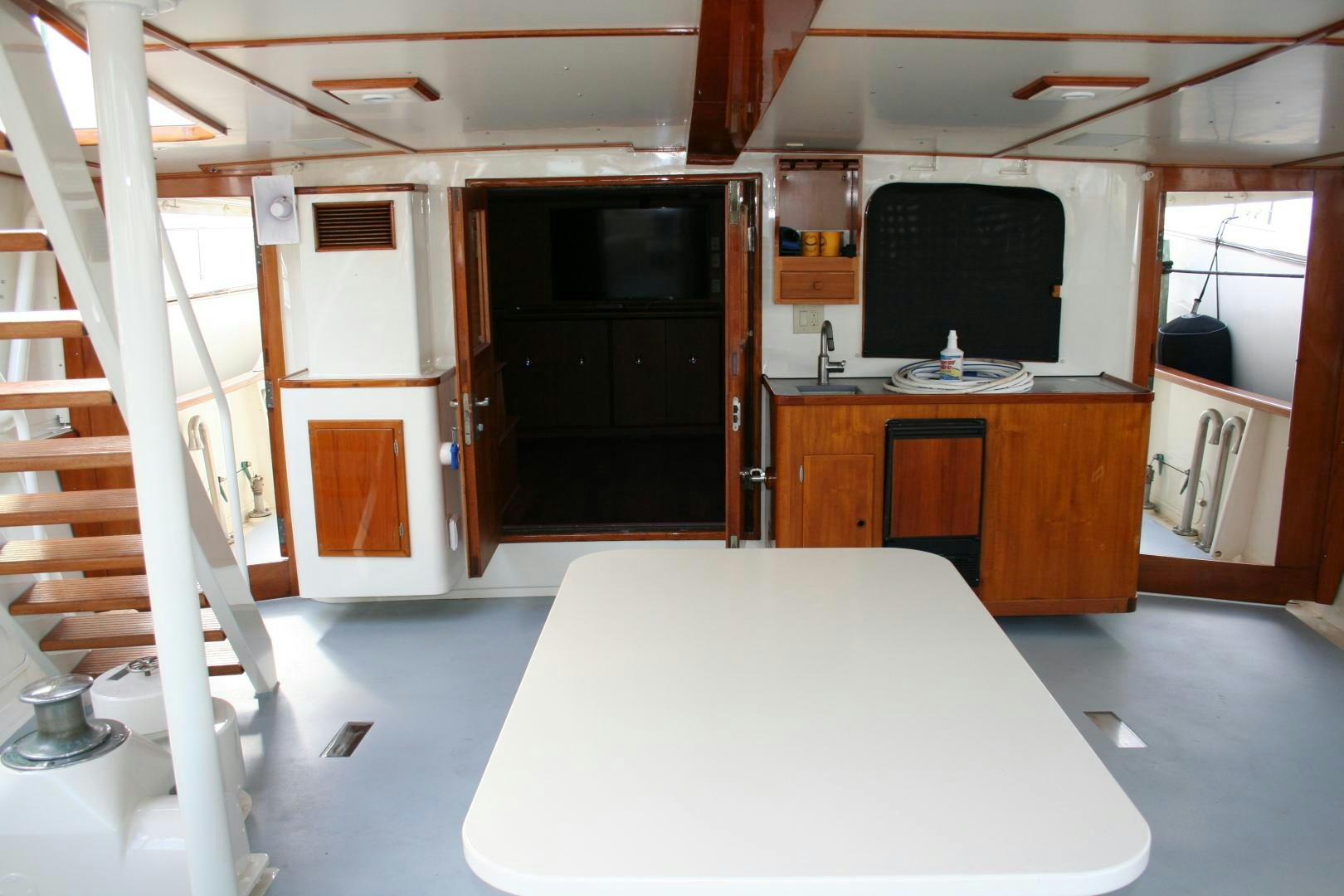 a room with a table and tv aboard SINDBAD Yacht for Sale